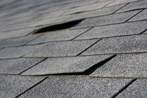 Damaged roof shingles in need of replacement